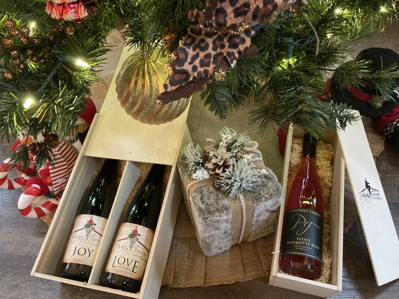 Wine bottles underneath the Christmas tree.